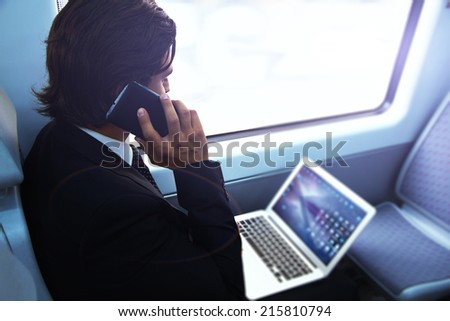 Businessman working with laptop on the way to work in train,man using modern devises, attractive businessman in suit using technology,businessman calling on the phone,businessman having a conversation
