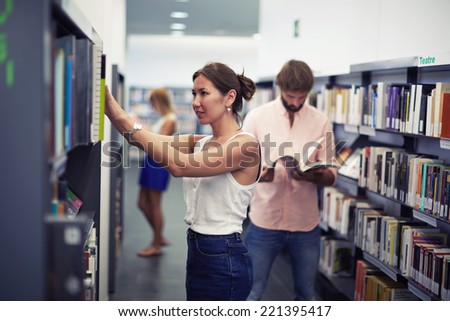 Asian student girl in library looking for some book in bookshelf, international students of high school at exam preparation looking for some books in library, entrance exams for students