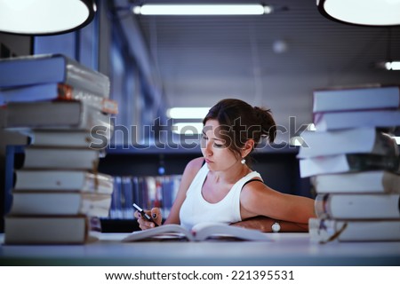 Night before finally exam, female student studying in library, asian college student seated at the desk with stack of books, female college student surrounded by books in a library