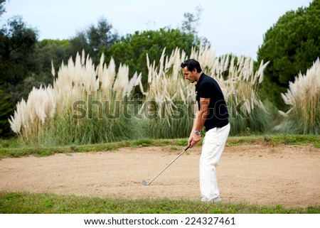 Golfer man playing on beautiful golf course, handsome adult man playing golf, attractive golfer hitting ball in action,rich wealthy man at leisure playing golf, strong golf shot of professional player