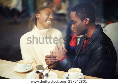 Laughing friends talk and drink coffee in cafe, good friend enjoying coffee in beautiful place, cold winter days in beautiful coffee shop, friends at breakfast having coffee and enjoying themselves