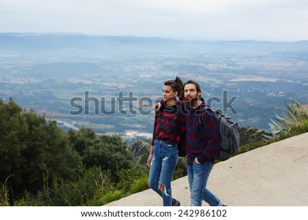 Beautiful young couple enjoying a hike together, couple of hikers walking down a hiking trail