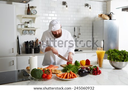 Professional cook cut vegetables in the kitchen, experienced chef making pasta on big kitchen