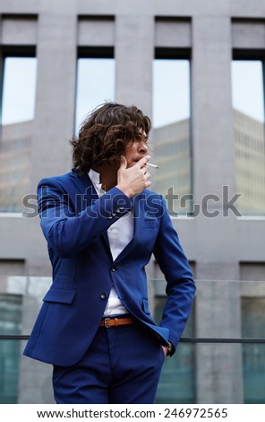 Portrait of a smart business executive smoking cigar looking concerned