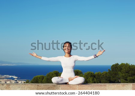 Portrait of smiling woman practicing yoga by raising her hands feeling so good and happy, young woman seeking enlightenment through meditation, relaxed girl performing and enjoy yoga routine, filter