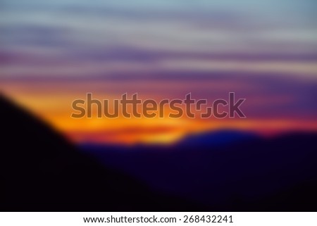 Beautiful colorful sunset with clouds in mountain landscape special blur effect for text, copy space area