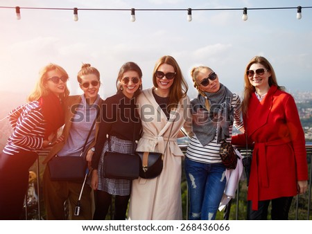 Large group of smiling girlfriends staying together at sunny day and looking at camera, vacation travel holidays wit best friends, smiling women