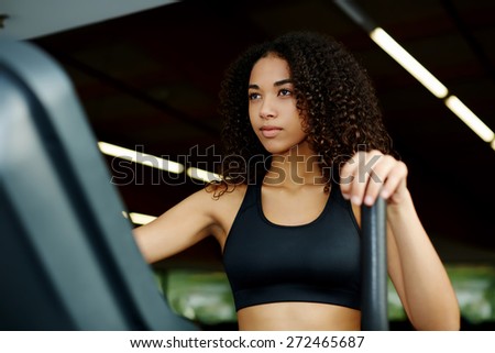 An attractive sexy woman working out in fitness center on stepping machine