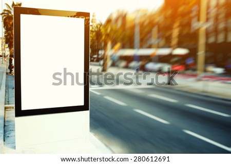 Blank billboard with copy space for your text message or content, outdoors advertising mock up, public information board on city road, flare sun light and motion blur effect