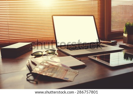 Successful businessman or entrepreneur table with style accessories,digital tablet and euro bills, open laptop computer with white blank copy space screen for text information or content, e-business