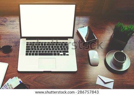 Freelancer needs mock up on wooden table in home interior, electronic business and distance work concept, laptop computer and digital tablet with white blank copy space screen and accessories lying