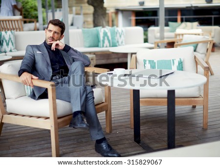 Successful intelligent business man relaxing in a luxury restaurant outdoors, confident thoughtful entrepreneur, wealthy men pensive rest and waiting someone in the modern coffee shop terrace