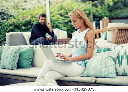 Young successful business woman work on a laptop during morning breakfast, women entrepreneur with her net-book sitting on the terrace of modern cafe,freelancer girl working at coffee shop on computer