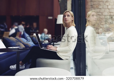 Thoughtful female person sitting in modern coffee shop interior with open laptop computer student girl doing course work on her laptop computer at the library,young businesswoman at work break working