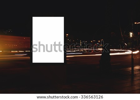 Blank billboard with copy space for your text message or content, electronic advertising mock up, public information board with movement of cars on the background, empty poster in urban setting