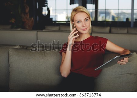 Female calling via mobile phone to her partner for tell about the monthly income results which she received via email on portable digital tablet, successful businesswoman talking on cell telephone