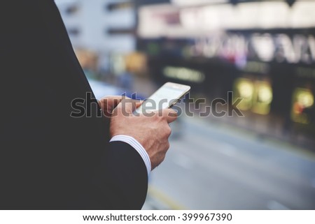 Closeup of man`s hands is holding cellphone with empty copy space screen for your advertising text message or promotional content. Closely of businessman search information in network via smart phone
