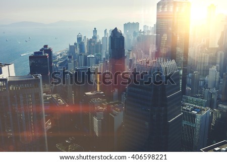 View from the roof of a modern city with tall office and commercial buildings at beautiful sunset. Developed business district with high skyscrapers with contemporary architecture in New York