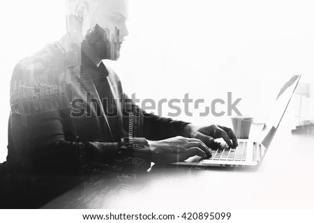 Double exposure black and white effect with young serious man successful trader is monitoring exchange trading via laptop computer. Skilled businessman is working on net-book. Global using of internet