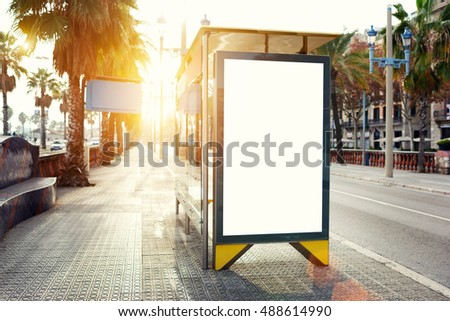 Blank billboard with copy space area for your text message or promotional content, public information board in urban setting, metropolitan city bus stop with empty mock up banner for your advertising