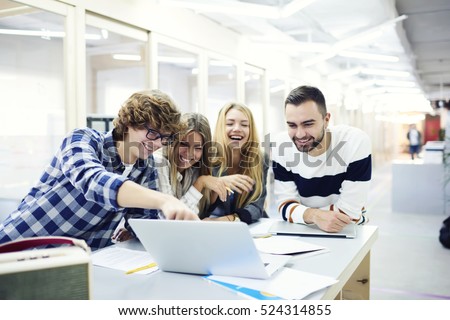 Team members of business company spending their free time discussing streaming video from popular blog having fun feel happiness during work break sitting in coworking place in friendly atmosphere