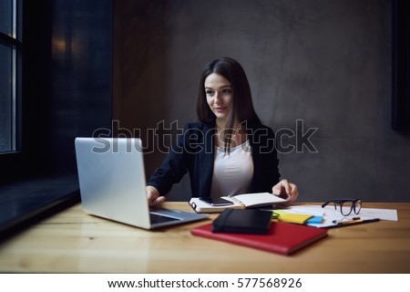 Attractive female administrative manager of restaurant chatting with marketing experts planning to set advertising campaign on websites searching company to place service in the hands of customers