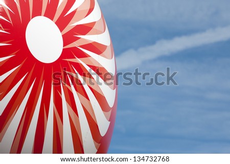 Balloon over blue sky. Happy emotions concept. Part of balloon with happy pattern.