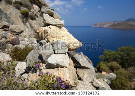 Pile of stones near the sea; pile of stones with the Mediterranean sea in the background.