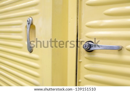 Door handles on vintage van turned into camper. This type of Vans was produced between 1947 and 1981 and is still popular among fans. It can be immediately recognized by distinctive corrugated body.