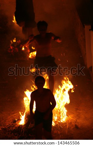 MASOURI, GREECE - JUNE 23: Locals and some of the tourists celebrate summer solstice by running several times through flames on June 23, 2010  in the village Masouri on Greek island of Kalymnos.