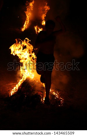 MASOURI, GREECE - JUNE 23: Locals and some of the tourists celebrate summer solstice by running several times through flames on June 23, 2010  in the village Masouri on Greek island of Kalymnos.