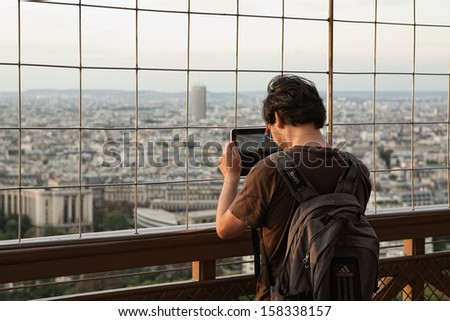 Paris - September 10: A Tourist Visiting The Eiffel Tower Is Taking Panoramic Photo Of Paris By Using His Apple Ipad Tablet Computer In The Warm Autumn On September 10, 2011 In Paris, France.