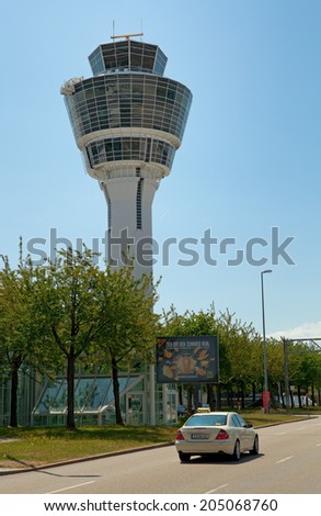 MUNICH, GERMANY - JUNE 27, 2014: Control tower of Munich airport. View of the Terminalstrasse road and airport control tower.