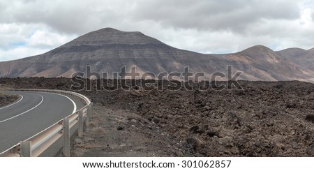 Lanzarote volcanic landscape: huge fields of lava material and some volcanoes in between. Almost 300 years since the eruption, but majority of the land is still barren land.