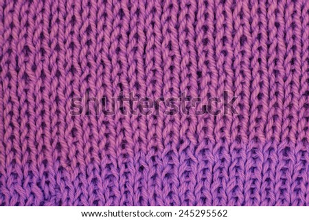 Knit woolen texture. Fabric violet background
