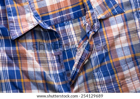 Colorful checkered shirt, closeup the fastener and collar useful as background