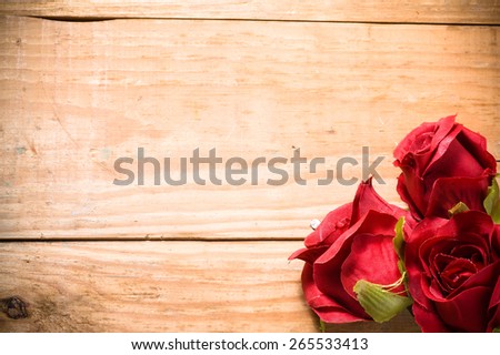Red roses flowers on a vintage wooden planks background, greeting and invitation cards