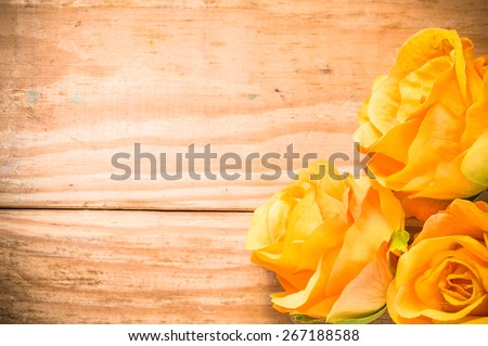 Tea roses, orange flowers on a brown, vintage wooden planks background, wedding card, greeting card and invitation card