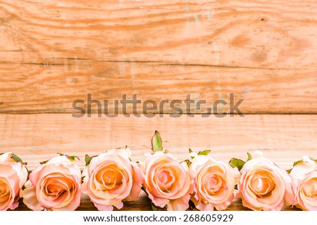 Pink roses flowers on a brown, vintage wooden planks background, wedding invitation, greeting card, mothers day and invitation card