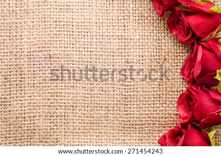 Romantic red roses on jute background. Floral backgrounds for mothers day card, wedding invitation, greetings card, and invitation cards