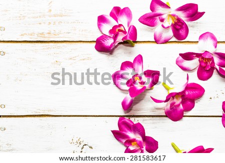 Orchid flowers on a wood background useful as invitation cards and greeting card