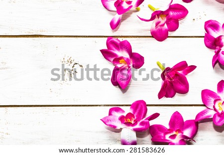 Orchid flowers on a wood background useful as invitation cards and greeting card