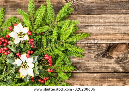 Beautiful Christmas background made from green tree of spruce and Christmas decoration on rustic wood background.