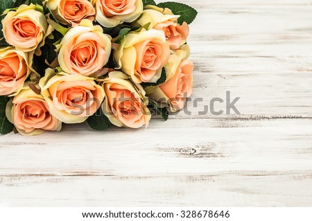 Valentine roses on rustic wood background. Flowers backgrounds.