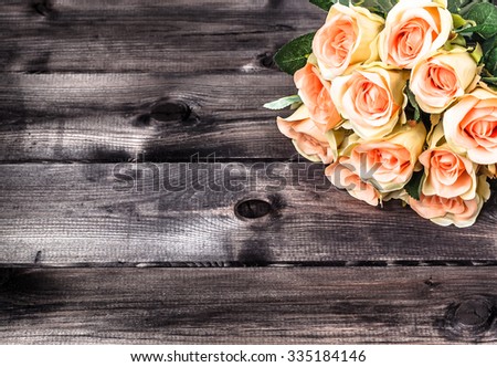 Valentines roses on rustic wood background. Flowers backgrounds.