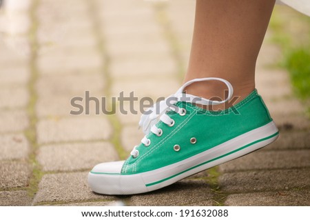 Bride\'s leg in green gym shoe