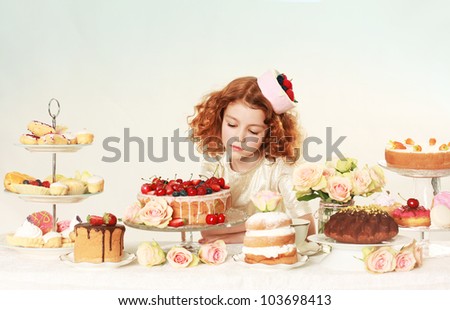 Little beautiful girl with cakes. Studio shot