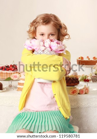 Little girl with flowers. Birthday party