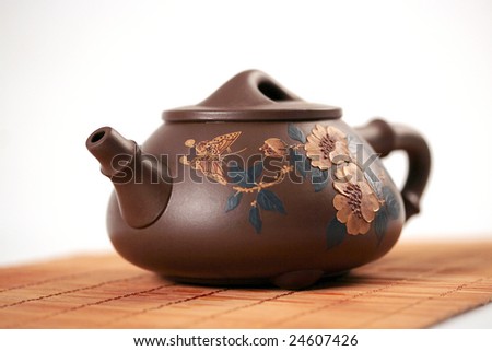 Ceramic teapot with flower ornament