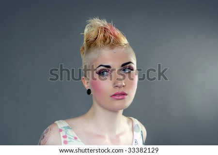 stock photo : Portrait of beautiful woman with tattoo, piercing and mohawk